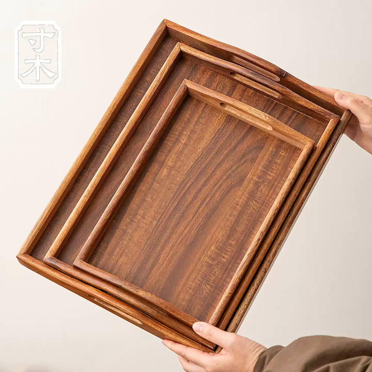 Three rectangular walnut serving trays shown together to compare their sizes