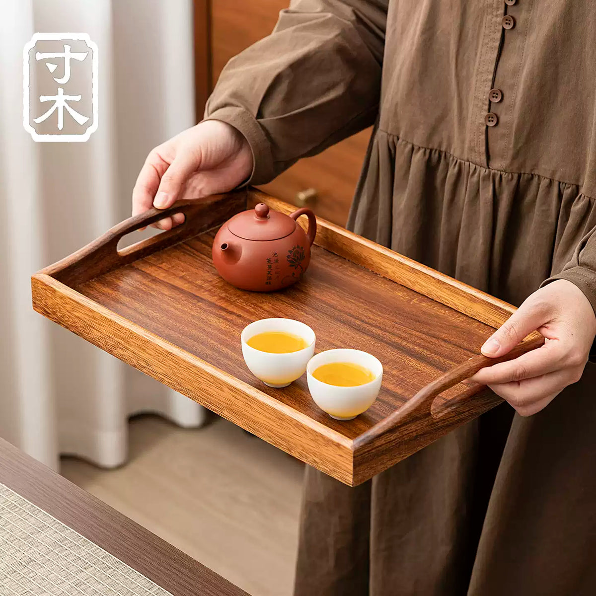 Walnut wood tray with curved handles carrying a teapot and two tea cups